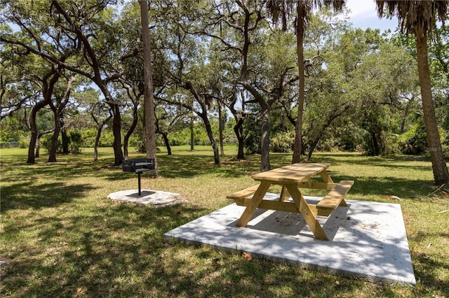 7520 Mako Dr, Hudson, FL 34667 - view of community with a lawn and view of wooded area