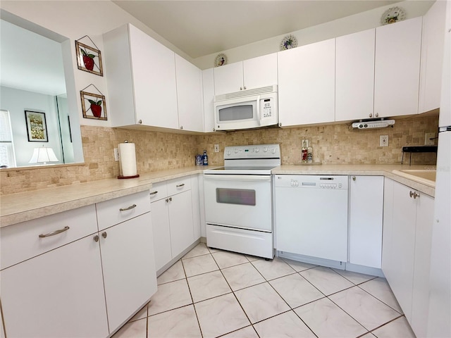 11631 Bayonet Ln, New Port Richey, FL 34654 - kitchen featuring white appliances, light countertops, and backsplash