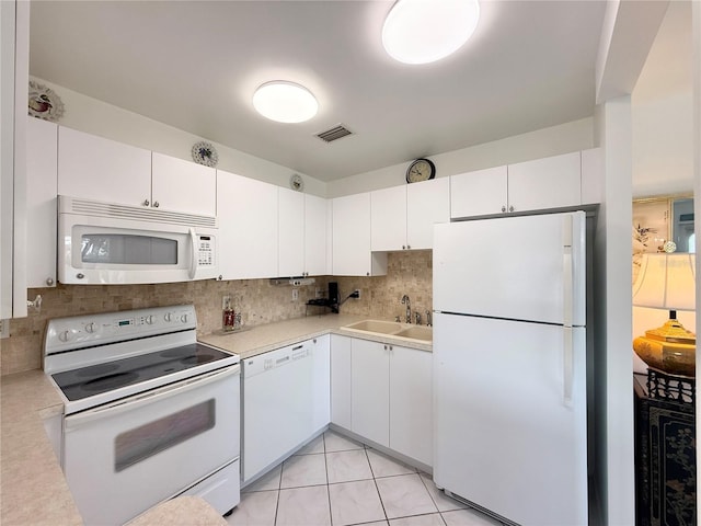 11631 Bayonet Ln, New Port Richey, FL 34654 - kitchen with white appliances, a sink, light countertops, and decorative backsplash
