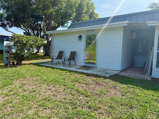 11631 Bayonet Ln, New Port Richey, FL 34654 - rear view of house with a yard, metal roof, a patio area, and a standing seam roof