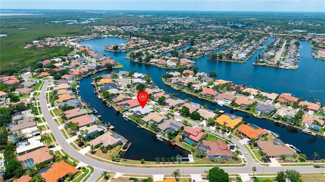 aerial view of property's location featuring a large body of water and nearby suburban area