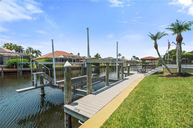 dock area featuring boat lift, a water view, a yard, and a residential view