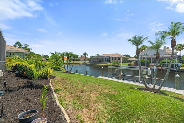 view of green lawn with boat lift, a dock, a water view, and a residential view