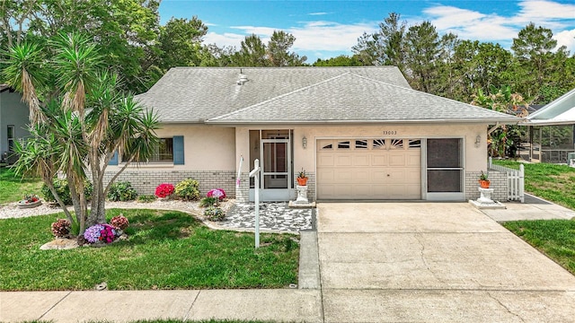 13003 Sandburst Ln, Hudson, FL 34667 - ranch-style house with roof with shingles, a garage, driveway, stucco siding, and a front lawn