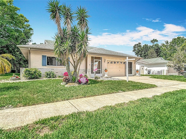13003 Sandburst Ln, Hudson, FL 34667 - single story home with driveway, stucco siding, a garage, and a front yard