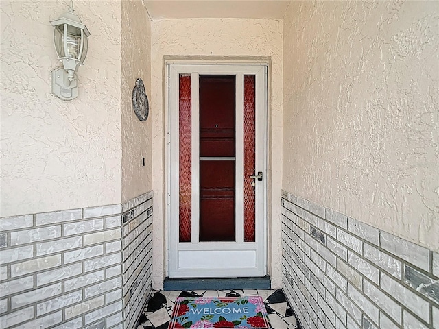13003 Sandburst Ln, Hudson, FL 34667 - doorway to property featuring stucco siding