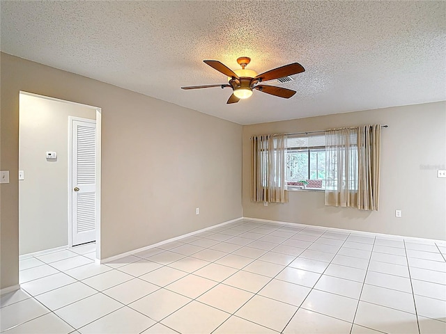 13003 Sandburst Ln, Hudson, FL 34667 - unfurnished room featuring ceiling fan, light tile patterned flooring, a textured ceiling, and baseboards