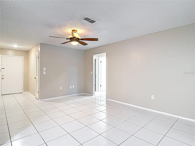 13003 Sandburst Ln, Hudson, FL 34667 - spare room featuring ceiling fan, light tile patterned flooring, a textured ceiling, and baseboards
