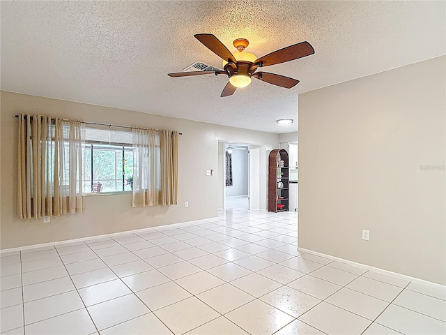 13003 Sandburst Ln, Hudson, FL 34667 - unfurnished room with a textured ceiling, a ceiling fan, light tile patterned flooring, and baseboards