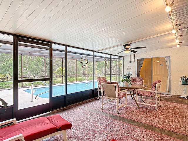 13003 Sandburst Ln, Hudson, FL 34667 - sunroom / solarium with ceiling fan, outdoor dining space, and rail lighting