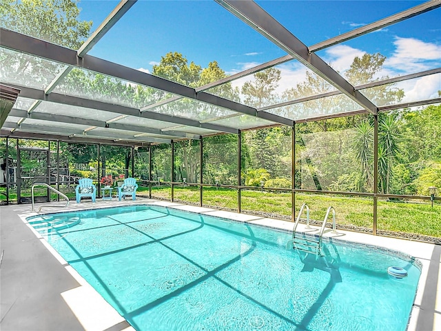 13003 Sandburst Ln, Hudson, FL 34667 - swimming pool with glass enclosure and a patio area