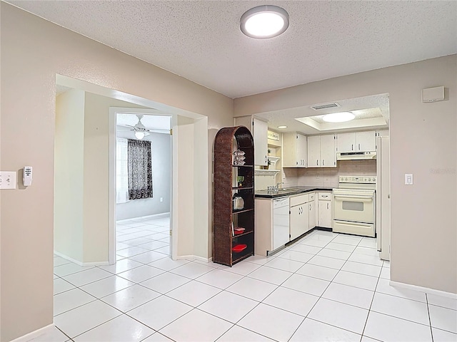 13003 Sandburst Ln, Hudson, FL 34667 - kitchen featuring white appliances, under cabinet range hood, dark countertops, a textured ceiling, and a sink