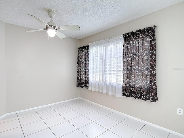 13003 Sandburst Ln, Hudson, FL 34667 - unfurnished room with a ceiling fan, light tile patterned floors, baseboards, and a textured ceiling