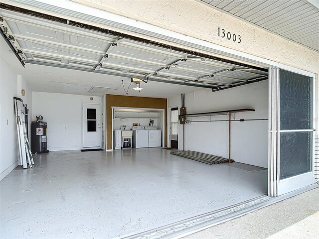 13003 Sandburst Ln, Hudson, FL 34667 - garage with washer and clothes dryer and water heater