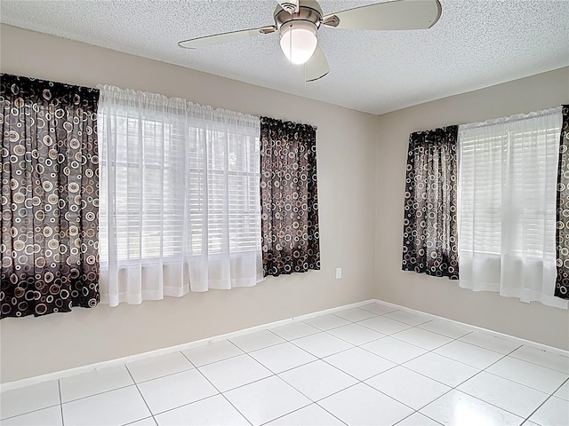 13003 Sandburst Ln, Hudson, FL 34667 - tiled empty room featuring ceiling fan and a textured ceiling