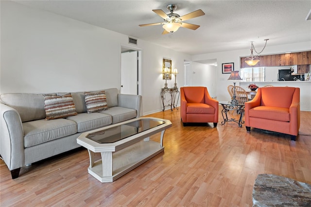 306 Martha Ln Unit 42, Oldsmar, FL 34677 - living room featuring light wood finished floors, a ceiling fan, and baseboards