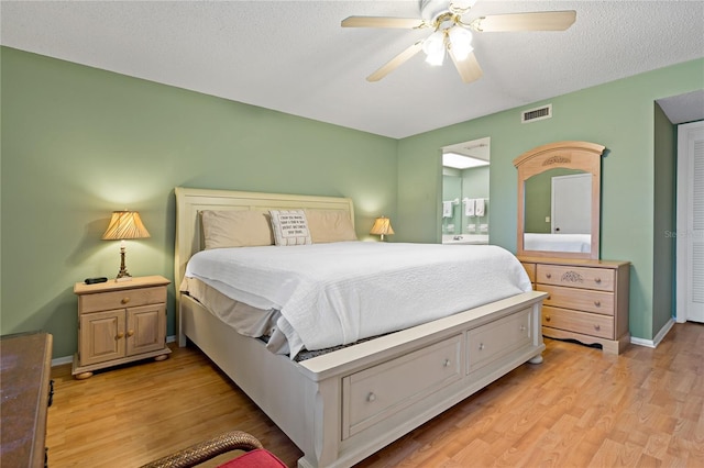 306 Martha Ln Unit 42, Oldsmar, FL 34677 - bedroom with light wood-style floors, ceiling fan, baseboards, and a textured ceiling