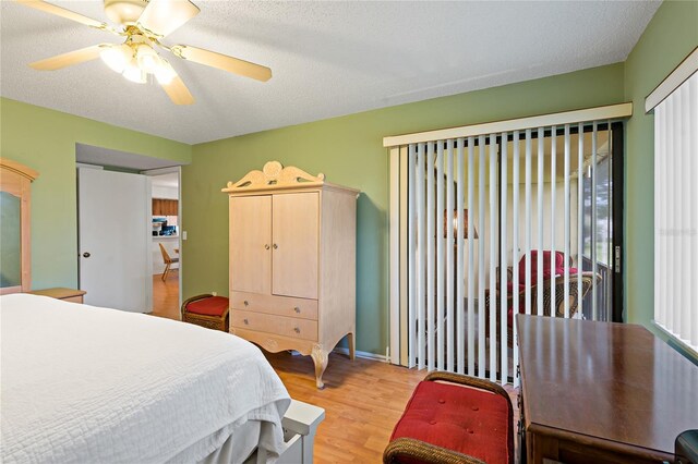 306 Martha Ln Unit 42, Oldsmar, FL 34677 - bedroom featuring light wood-type flooring, a ceiling fan, and a textured ceiling
