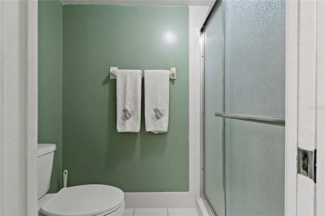 306 Martha Ln Unit 42, Oldsmar, FL 34677 - bathroom with toilet, a stall shower, tile patterned flooring, and baseboards