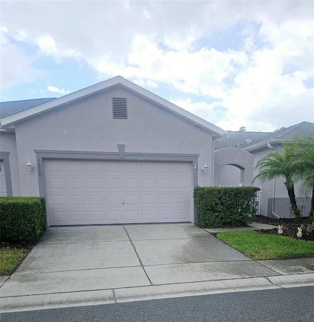 20720 Eustis Rd, Land O Lakes, FL 34637 - single story home with a garage, driveway, and stucco siding
