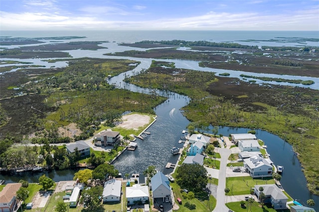 aerial view of property and surrounding area with a nearby body of water and nearby suburban area