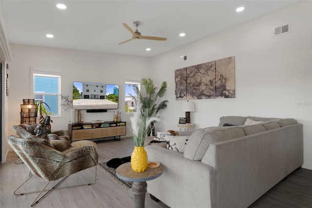 living room with wood finished floors, a ceiling fan, and recessed lighting
