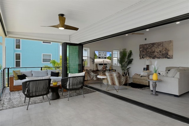 sunroom featuring ceiling fan and outdoor lounge area