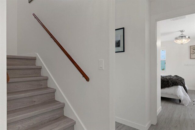 stairway featuring wood finished floors and baseboards