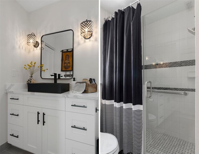 bathroom featuring a shower stall, vanity, and toilet