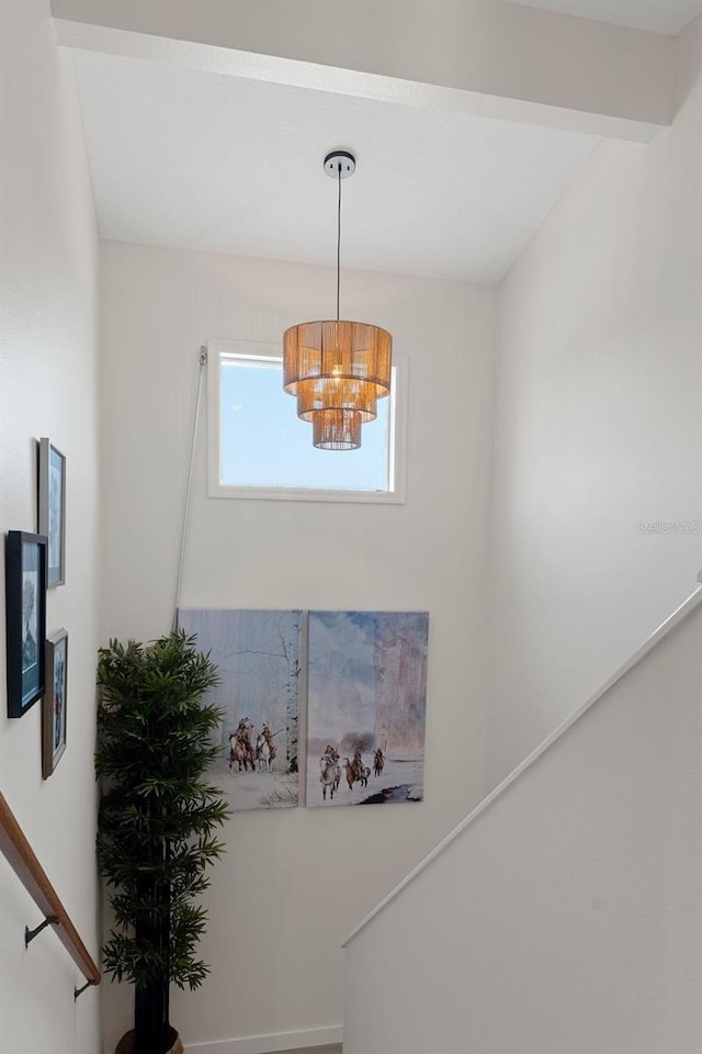 stairway with a chandelier