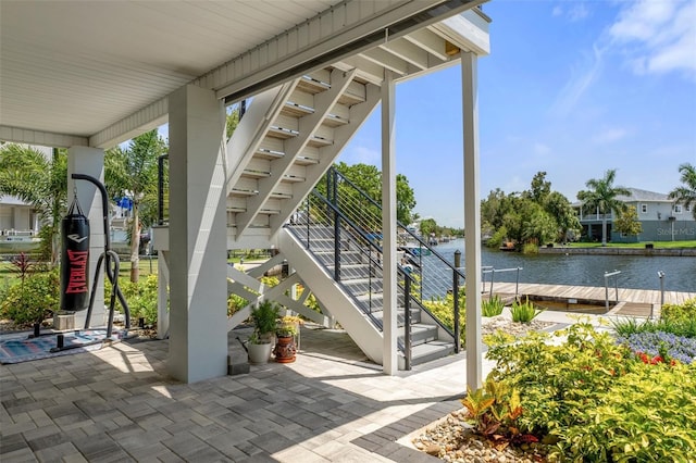 5234 Foxhall Ct, Weeki Wachee, FL 34607 - view of patio / terrace featuring stairs, a water view, and a boat dock