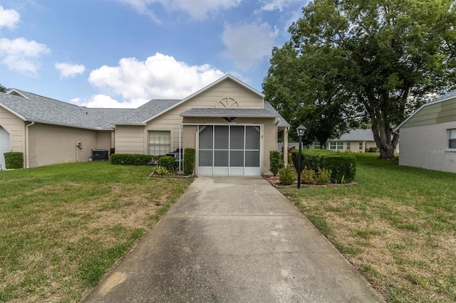 4837 Boonesboro Ct, New Port Richey, FL 34655 - ranch-style home featuring driveway, central AC, a front yard, and a shingled roof