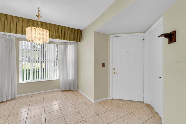 4837 Boonesboro Ct, New Port Richey, FL 34655 - foyer with a chandelier, light tile patterned floors, and baseboards