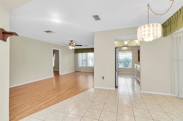 4837 Boonesboro Ct, New Port Richey, FL 34655 - spare room featuring ceiling fan, a chandelier, light tile patterned flooring, and baseboards