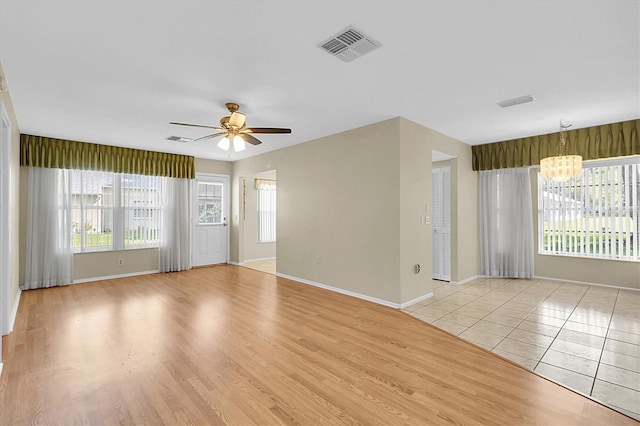 4837 Boonesboro Ct, New Port Richey, FL 34655 - spare room with a chandelier, a ceiling fan, baseboards, and light wood-type flooring