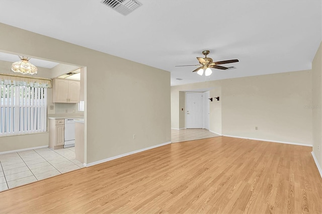 4837 Boonesboro Ct, New Port Richey, FL 34655 - empty room with light wood-type flooring, a ceiling fan, and baseboards