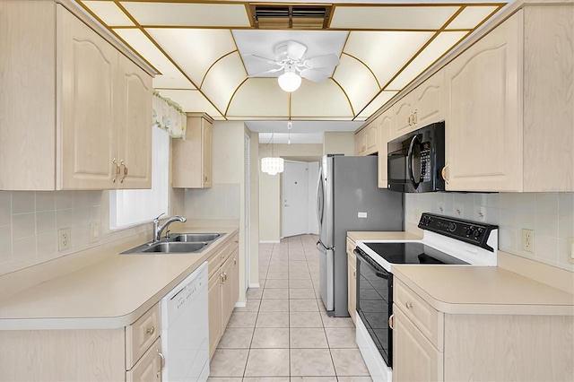 4837 Boonesboro Ct, New Port Richey, FL 34655 - kitchen with range with electric cooktop, black microwave, dishwasher, a sink, and light tile patterned floors