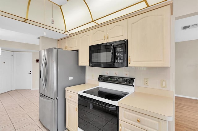 4837 Boonesboro Ct, New Port Richey, FL 34655 - kitchen with black microwave, range with electric cooktop, stainless steel fridge, decorative backsplash, and light countertops