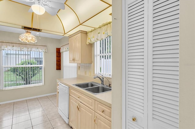 4837 Boonesboro Ct, New Port Richey, FL 34655 - kitchen featuring white dishwasher, a sink, baseboards, light brown cabinetry, and light countertops