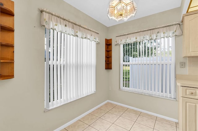 4837 Boonesboro Ct, New Port Richey, FL 34655 - unfurnished dining area featuring a chandelier, baseboards, and light tile patterned flooring