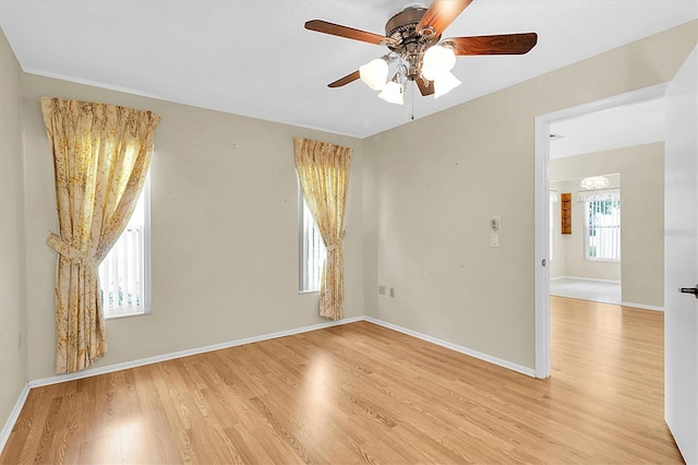 4837 Boonesboro Ct, New Port Richey, FL 34655 - empty room featuring light wood-type flooring, ceiling fan, and baseboards