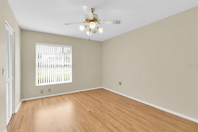 4837 Boonesboro Ct, New Port Richey, FL 34655 - unfurnished bedroom with light wood finished floors, a closet, baseboards, and a ceiling fan