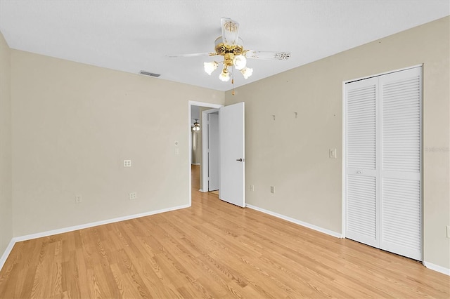 4837 Boonesboro Ct, New Port Richey, FL 34655 - unfurnished bedroom featuring light wood-type flooring, baseboards, a closet, and ceiling fan