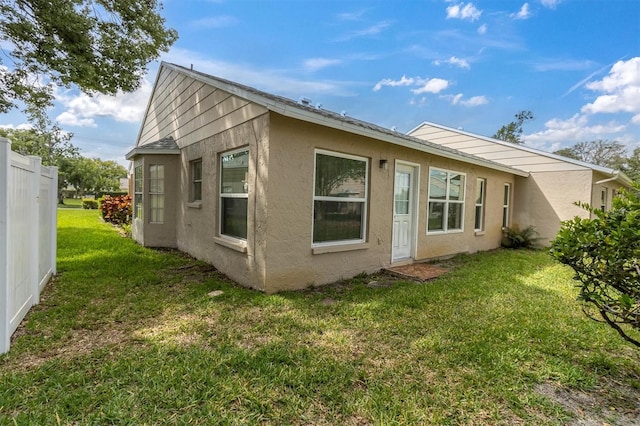 4837 Boonesboro Ct, New Port Richey, FL 34655 - back of property with a yard and stucco siding