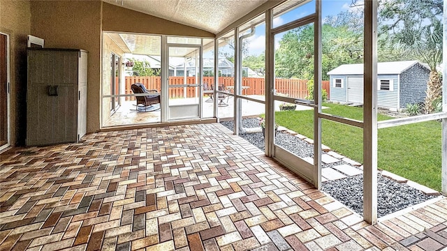 unfurnished sunroom featuring lofted ceiling
