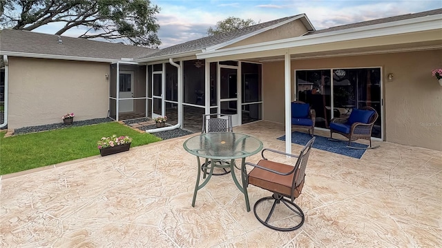 view of patio with a sunroom