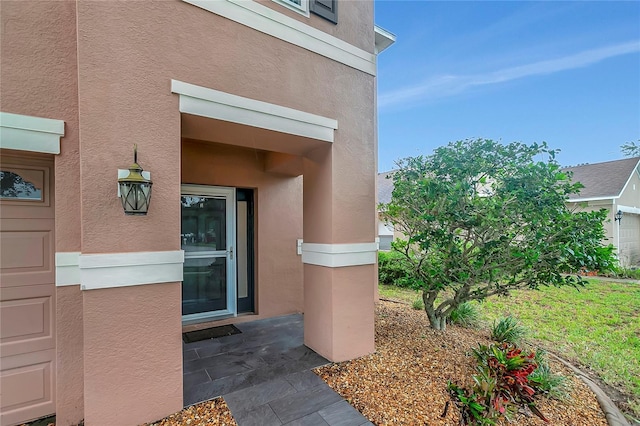 doorway to property with stucco siding