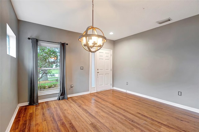 unfurnished dining area with a chandelier, baseboards, light wood-type flooring, and recessed lighting