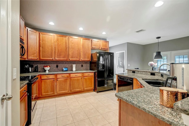 kitchen featuring black appliances, a sink, decorative backsplash, light stone counters, and light tile patterned flooring