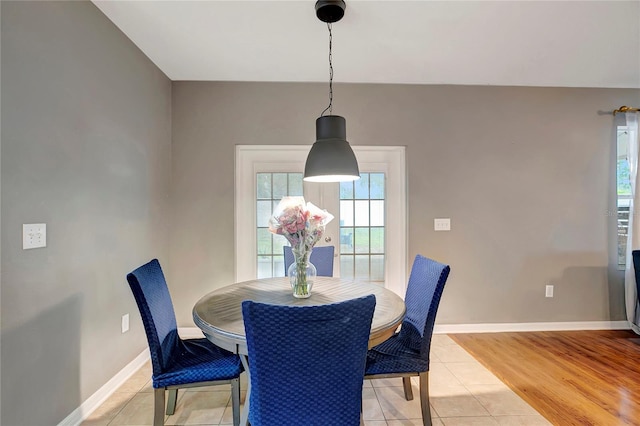 dining room featuring baseboards and light tile patterned flooring